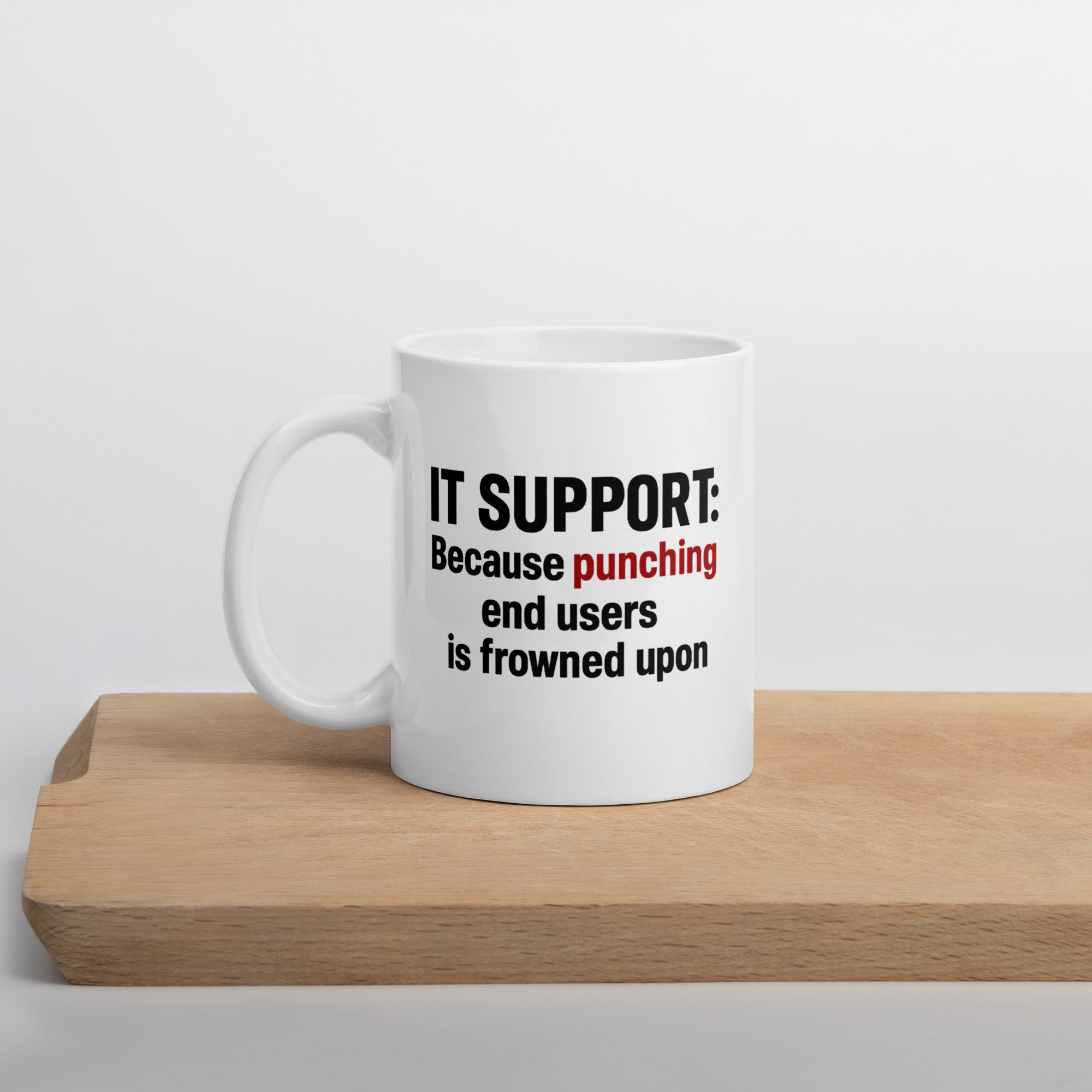 White mug with bold black and red text that reads, “IT Support: Because punching end users is frowned upon.”