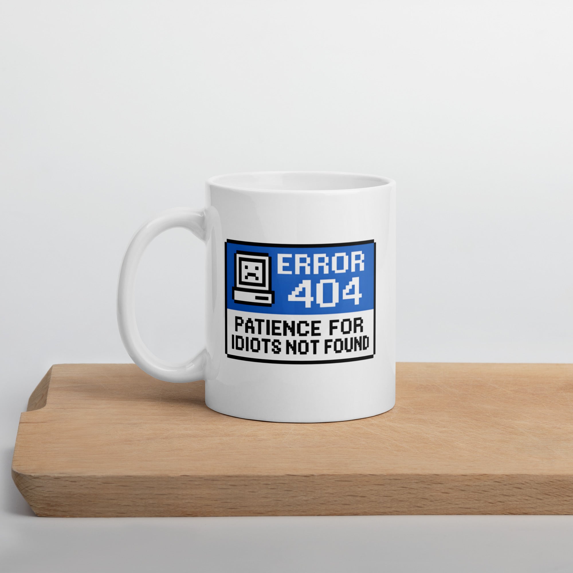 Funny tech coffee mug with quote “Error 404: Patience for Idiots Not Found” in retro blue computer design.