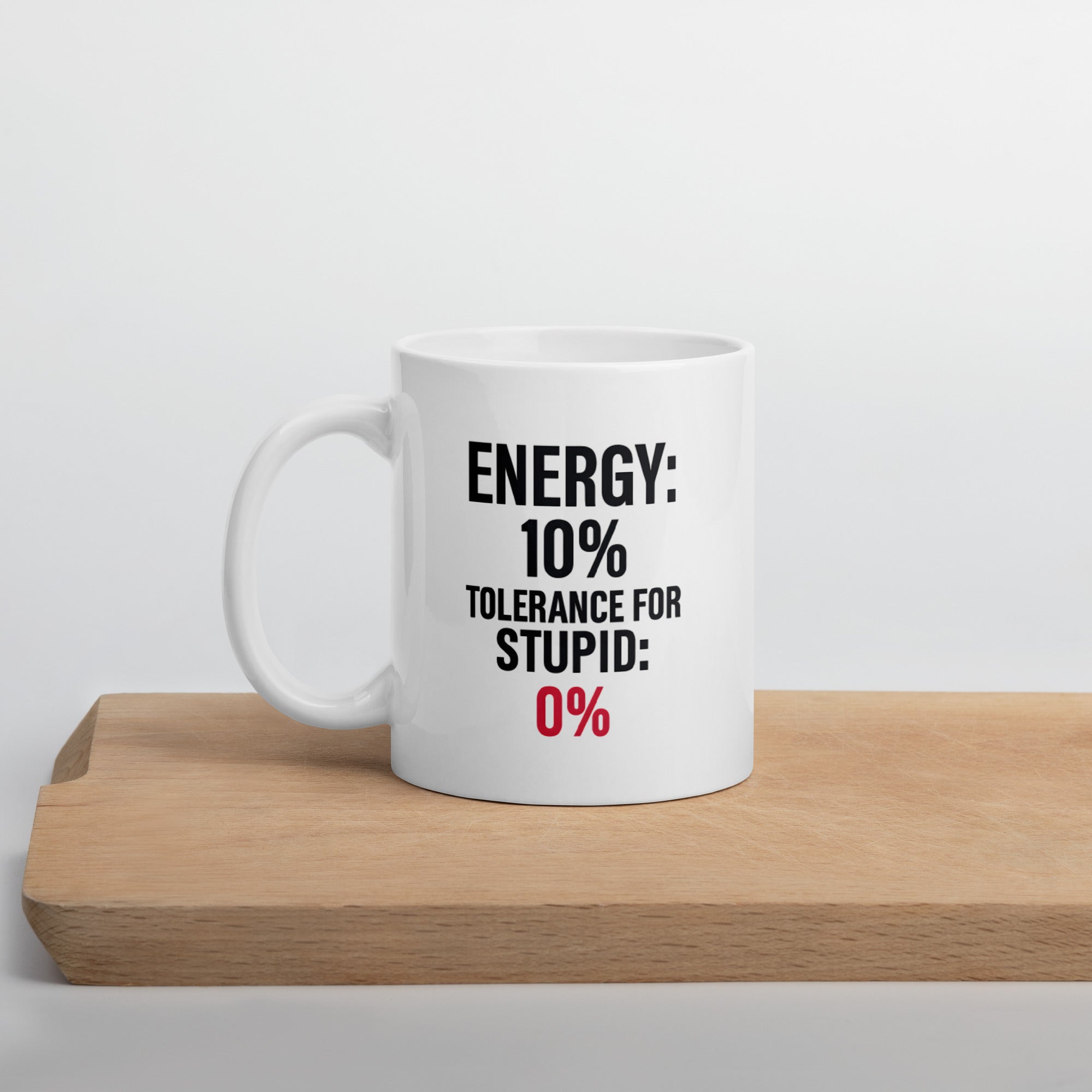Funny sarcastic coffee mug with quote “Energy 10% Tolerance for Stupid 0%” in black and red text.